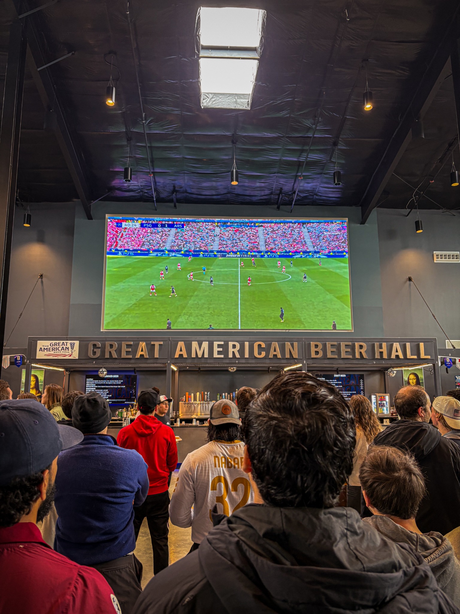 Soccer on the giant screen above the GABH bar